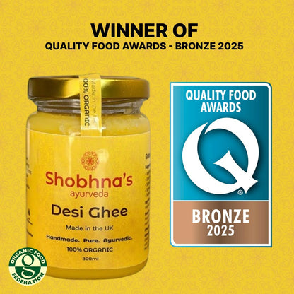 Jar of Shobhna's Desi Ghee with Quality Food Awards bronze medal on a yellow background